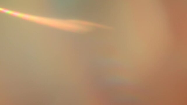 Holographic light on blurred orange sandy background