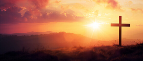 Cross silhouette on hill at sunrise