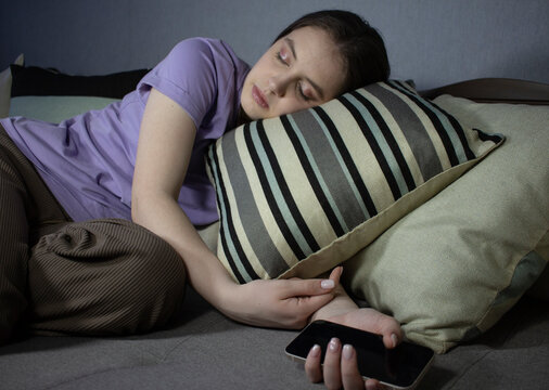 girl sleeping with smartphone on pillow