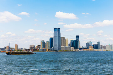 Fototapeta premium Jersey City skyline with skyscrapers and Hudson River on a clear day. Modern urban waterfront cityscape.