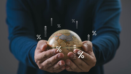 A person holding a small globe with rising percentage icons, symbolizing global economy growth, financial trends, investment opportunities, and international market expansion.