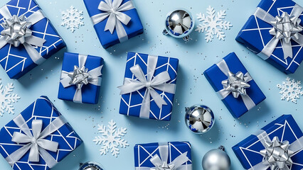 Top view of blue christmas gift box with silver ribbon and ornament