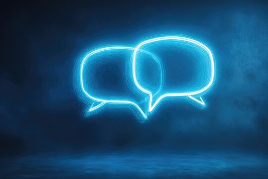 Glowing blue light of two connected speech bubbles on a dark, smoky background