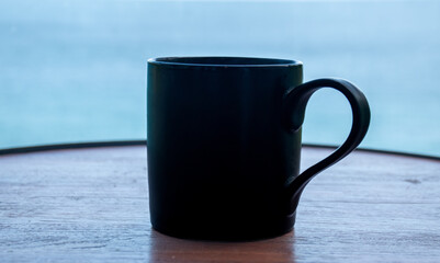 cup of coffee on wooden table