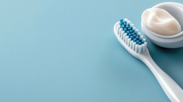 Toothbrush and toothpaste placed on a blue surface ready for morning dental care routine and hygiene - Powered by Adobe