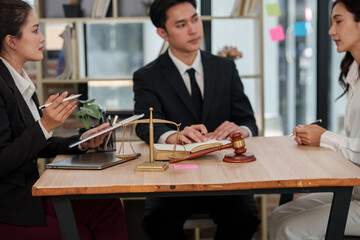 Group of male and female lawyers are giving legal advice in an office.