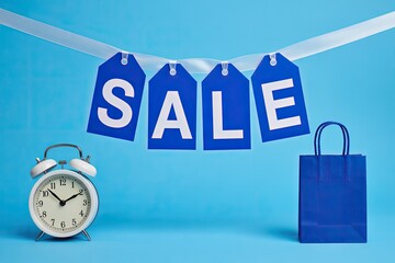 Blue Sale Banner with Shopping Bag and Alarm Clock for Seasonal Discount Promotion