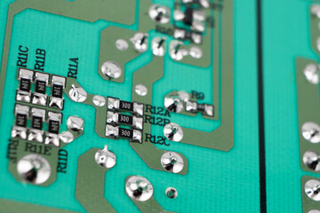 Fototapeta premium Circuit board with resistors microchips and electronic components background. Computer hardware technology. Integrated communication processor.