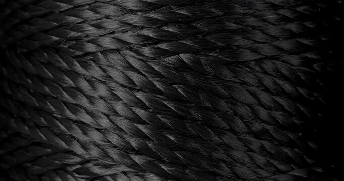 seamless woven texture background loop. texture of dark rough twine. video presenting a continuous dark gray woven thread texture.