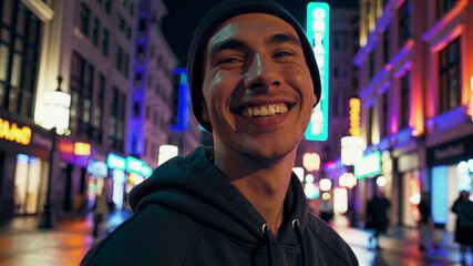 Young man enjoys vibrant city night with reflections on wet pavement in bustling urban scene - Powered by Adobe