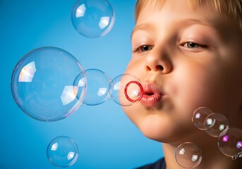 a close up portrait of a young boy blowing bubbles with a vibrant blue background capturing a moment of childhood joy and innocence high quality professional