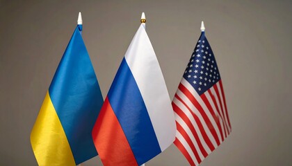 Flags of Ukraine, Russia, and the United States side by side, symbolizing global presence and identity.