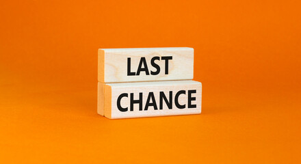 Last chance symbol. Concept word Last chance on beautiful wooden blocks. Beautiful orange paper...