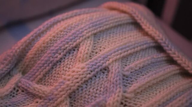 Close-up of soft, knitted fabric with braid pattern texture