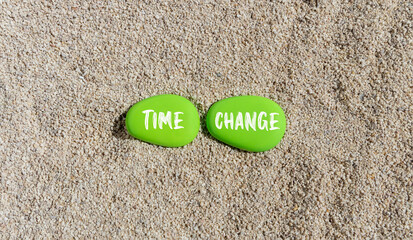 Time change symbol. Concept word Time change on beautiful green stones. Sea sand beach. Beautiful sand beach background. Business time change concept. Copy space.