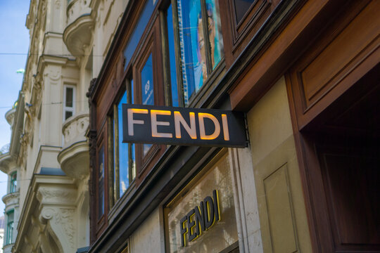 Vienna, Austria, Europe - Nov 08, 2025: illuminated Fendi luxury fashion store sign mounted on a dark fascia above large wooden-framed windows on a historic luxury shopping street