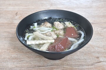 Vietnamese rice noodles or Pho with slice sausage and chop pork couple blood in soup on bowl  