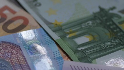 macro of cash bills in denominations of 100, 50, 20, 10, 5 euros rotating, cash money of the European Union, concept of Europe's economy and finance - Powered by Adobe