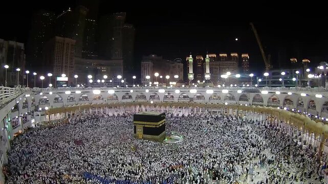 One evening, Muslims circumambulate the Kaaba.