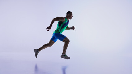 Runner captured mid-air stride during dynamic sprint. Concept of sports advertising, fitness campaign visuals, athlete technique training, and performance analytics content.