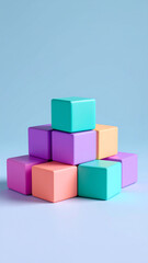 Obraz premium Balanced pile of soft stacked cubes plum teal sunflower and coral positioned light blue background creating calm and colorful