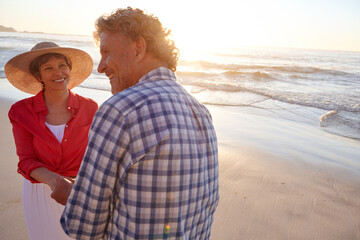 Love, couple and happy with holding hands on beach for anniversary, travel adventure and bonding. Space, mature people and relax together at seaside for summer holiday, romantic date and fresh air