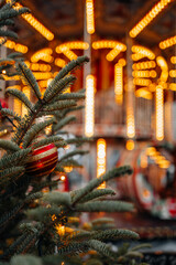 Red Christmas balls hanging on green Christmas tree branches,festive backdrop for winter holiday posters or postcards