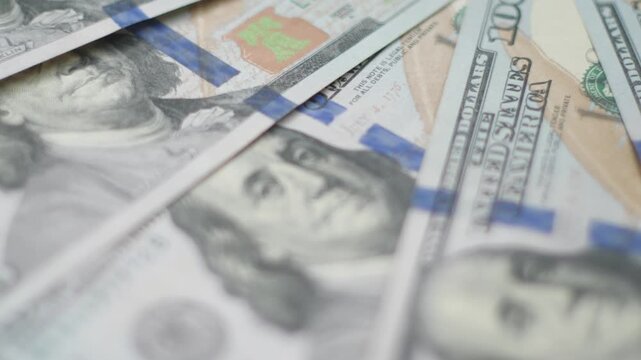 Close-up of Rotating Hundred Dollar Bills Stack, Macro Cash Dollars, Business and Finance Concept