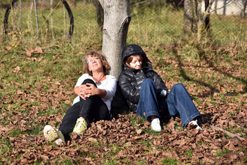 Women relaxing under a tree in autumn
