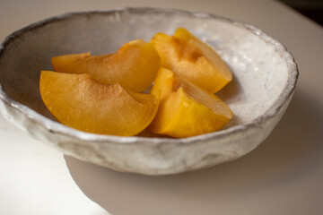 Peach on a plate. Pieces of fresh juicy peach on a plate.