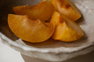 Peach on a plate. Pieces of fresh juicy peach on a plate.