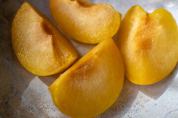 Peach on a plate. Pieces of fresh juicy peach on a plate.