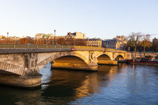The 1855 Pont des Invalides, an arch bridge over the Seine in the 7th arrondissement, seen during a golden hour morning, Paris, France