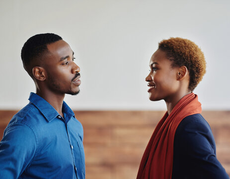 African American Couple Having Face to Face Conversation in Modern Setting