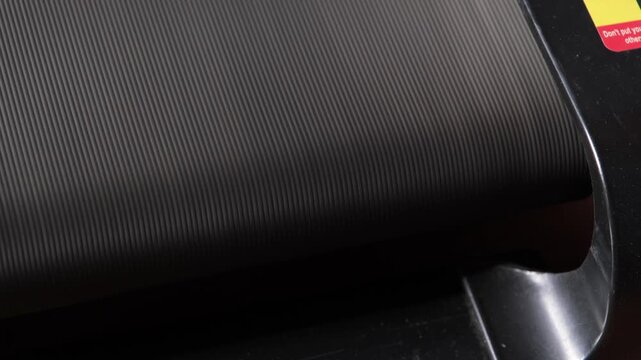 closeup of treadmill belt moving with steady whirring noise