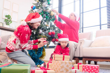 A young woman and her family smiling happily while celebrating Christmas or New Year.