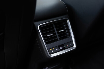 Air-condition panel in interior of a new car. Seat heating button in luxury car. Modern car central console with seat heating controls. Seat heating button in the car