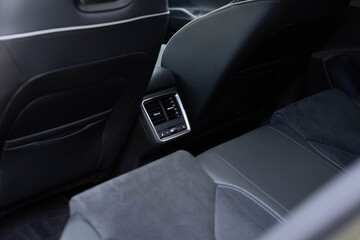 Modern car central console with seat heating controls. Seat heating button in the car. Air-condition panel in interior of a new car. Seat heating button in luxury car.