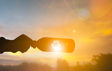 Recycling Bottle Silhouette with Eco Symbol at Sunset