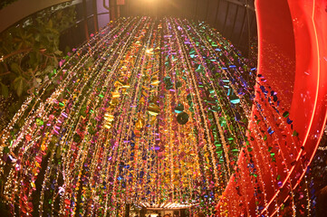 Texture and background of Plastic hanging with strings, illuminated with colored lights, sparkling and beautiful for Christmas day decorations.