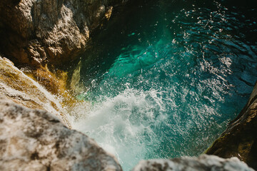 Majestic waterfall landscape with turquoise water and rocks, natural scenic beauty in motion, generative ai