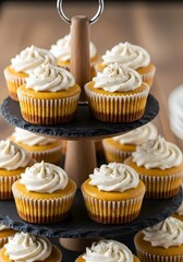 Autumn Pumpkin Spice Cupcakes with Creamy White Frosting and Sprinkles on a Rustic Slate Tiered Stand