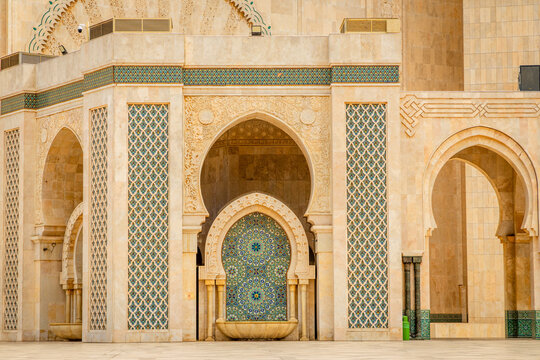 Decorative arch and mosaic fountain of the Hassan II Mosque with carved stone details and traditional Moroccan zellij tilework, Casablanca, Morocco
