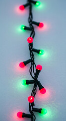 Close-up of string light with red and green bulb. It symbolizes festive mood, celebration, and holiday spirit, ideal for Christmas decoration