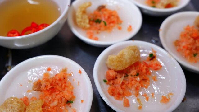 Small ceramic bowls of Banh Beo, steamed rice cakes topped with savory dried shrimp, crispy pork cracklings, and scallion oil.