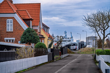 Charming Yellow Cottages With Red Tile Roofs And White Fences On A Quiet Street, Skagen Denmark