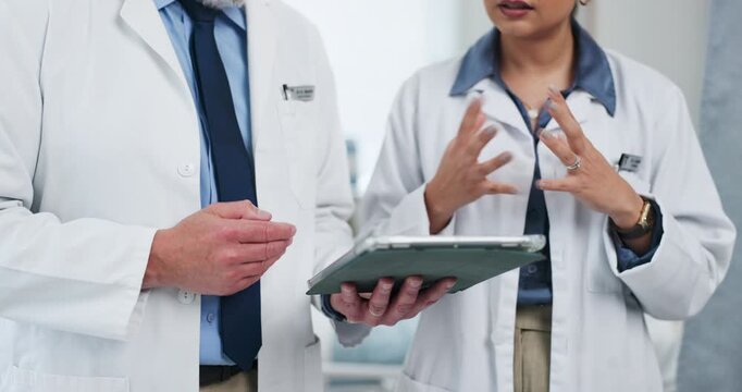 Hands, doctors and tablet with team, planning and discussion with review, feedback or report at clinic. People, medical professional and explain with app, insight and healthcare solution at hospital
