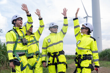Workers celebrate teamwork and success at a wind farm during a sunny afternoon in the countryside © Freeday photo
