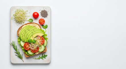 Vibrant healthy avocado toast flat lay with fresh vegetables and sprouts on a white wooden board, perfect for text.
