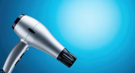 Sleek Silver Hair Dryer with Black Accents on a Vibrant Blue Gradient Background, Offering Ample Copy Space.